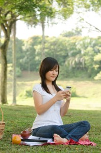 A college student on campus with smartphone